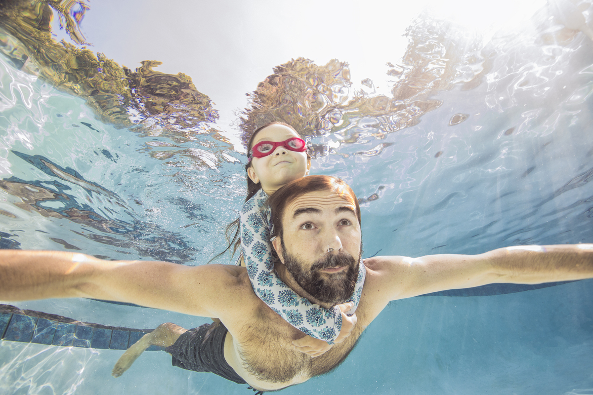 muž s dcerou zadržují dech pod vodou