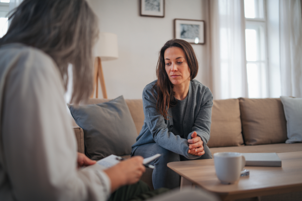 Dospělá žena sedí na gauče u své psychoterapeutky a vypráví jí důvod své návštěvy